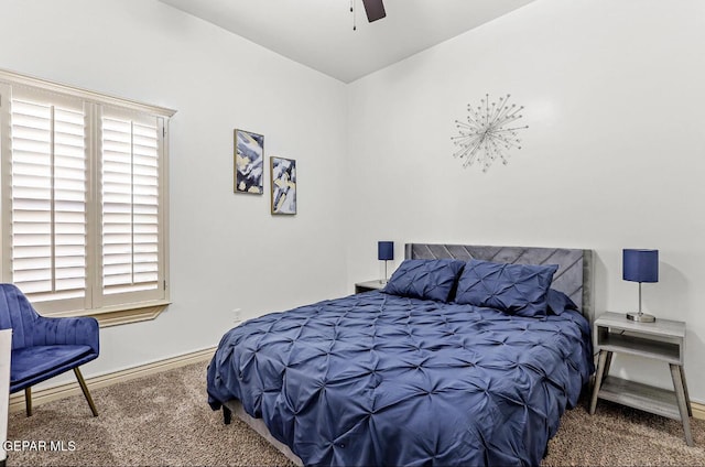 carpeted bedroom with ceiling fan and baseboards