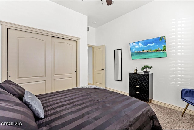 bedroom featuring carpet floors, a closet, baseboards, and a ceiling fan