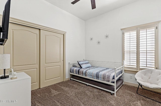 carpeted bedroom with ceiling fan and a closet