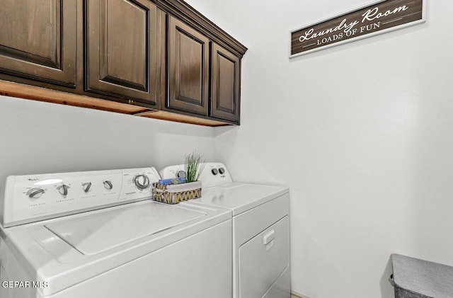 laundry room featuring independent washer and dryer and cabinet space