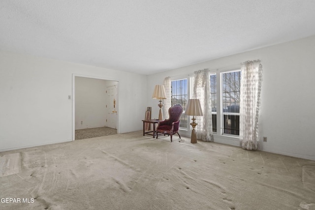 unfurnished room featuring light carpet and a textured ceiling