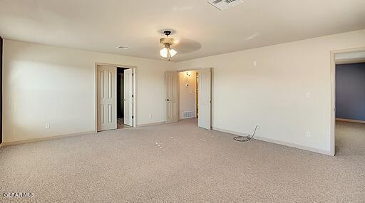 unfurnished room with light colored carpet, visible vents, and baseboards