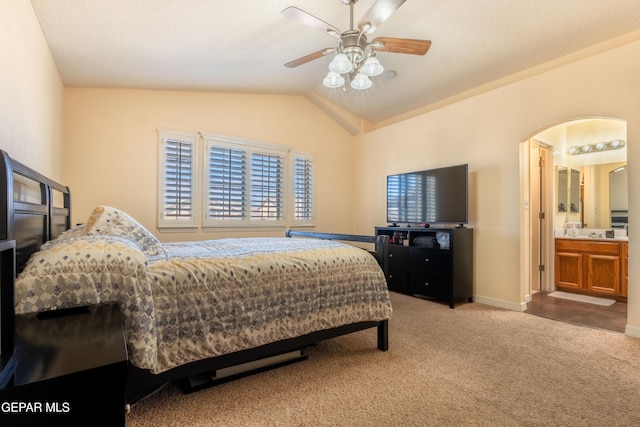 bedroom with arched walkways, ceiling fan, baseboards, vaulted ceiling, and carpet