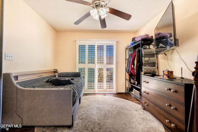 bedroom with a textured ceiling and ceiling fan