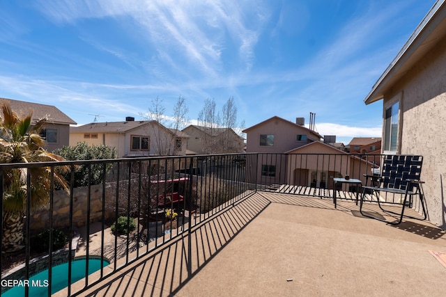 view of patio / terrace with a balcony and a residential view