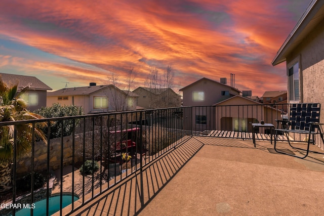 3612 Tierra Calida Dr, El Paso, TX 79938 - patio terrace at dusk with a balcony and a fenced in pool