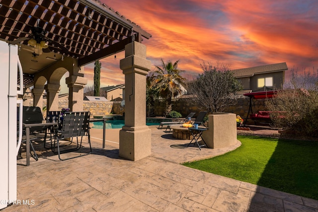 3612 Tierra Calida Dr, El Paso, TX 79938 - patio terrace at dusk with a fenced backyard, a fire pit, an outdoor pool, and a pergola
