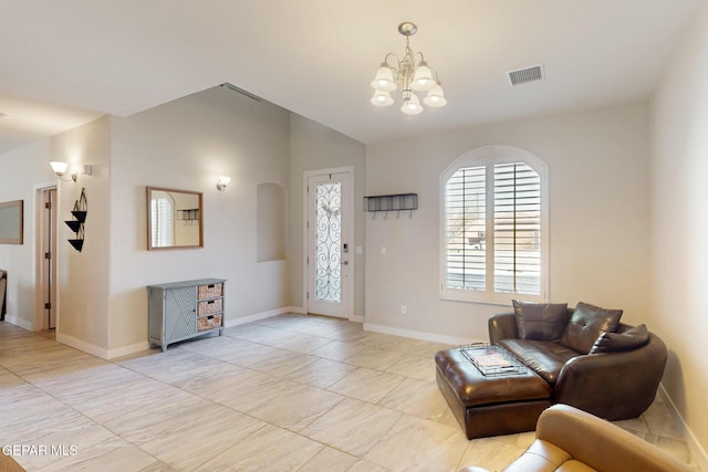 living room with lofted ceiling, an inviting chandelier, baseboards, and visible vents