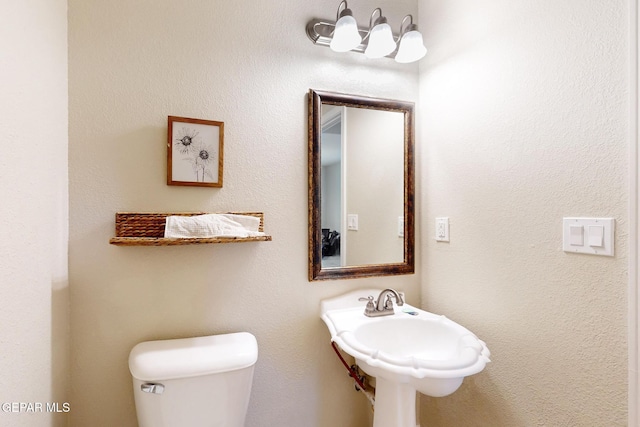 bathroom featuring toilet and a sink