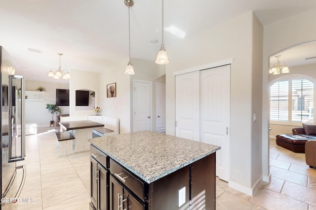 kitchen featuring a chandelier, a center island, pendant lighting, and open floor plan