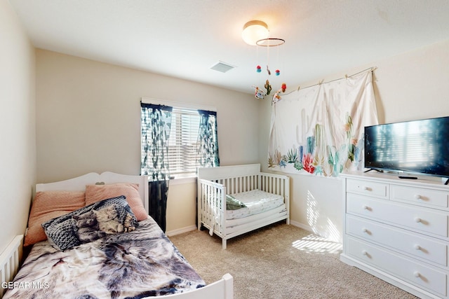 bedroom featuring light carpet, baseboards, and visible vents