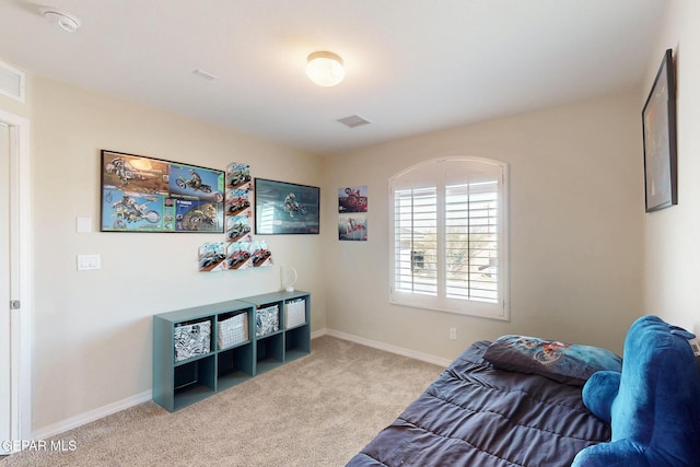 bedroom with baseboards, visible vents, and light colored carpet