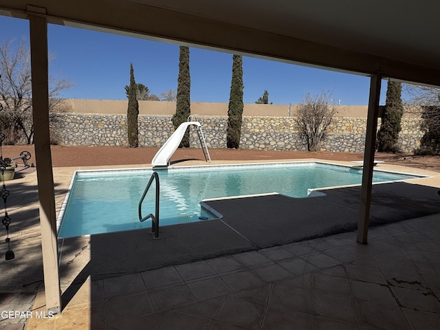 view of pool with a water slide, a fenced backyard, and a fenced in pool