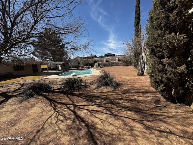 view of swimming pool featuring a fenced in pool, a water slide, and a patio