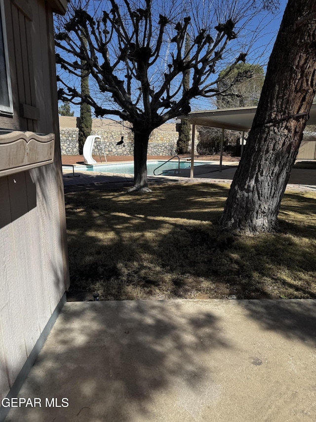 view of yard featuring a carport and a patio