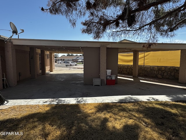 view of parking / parking lot featuring fence