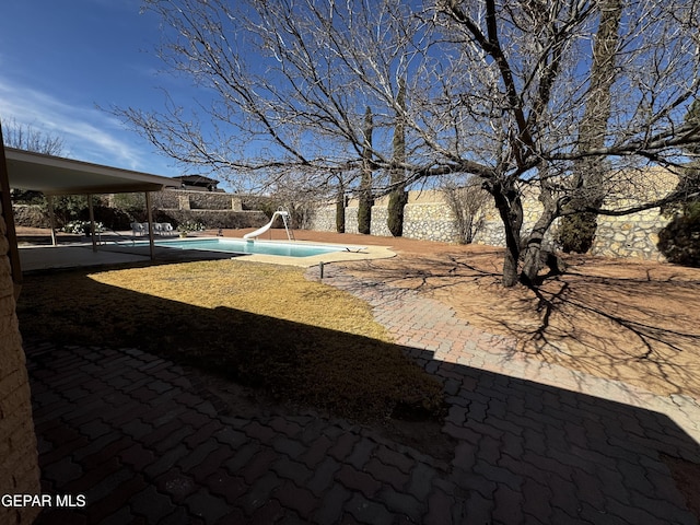 view of yard with a patio area and a fenced in pool