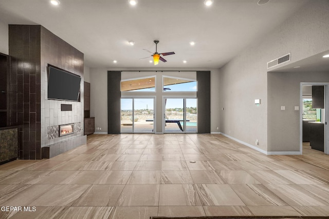425 Golden Springs Dr, El Paso, TX 79912 - unfurnished living room with baseboards, a fireplace, visible vents, and a wealth of natural light