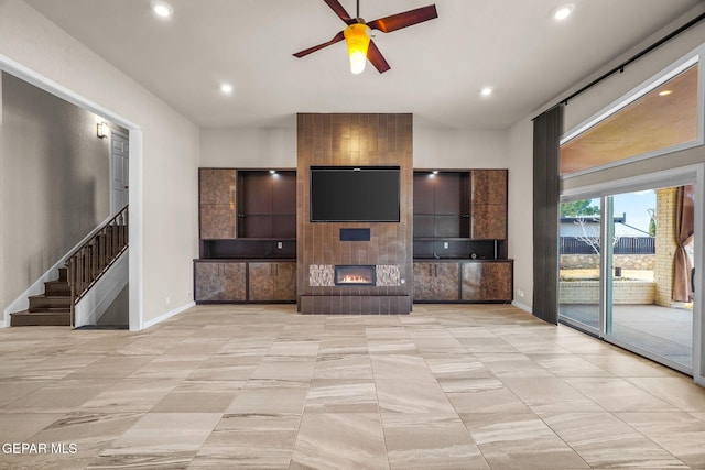 425 Golden Springs Dr, El Paso, TX 79912 - unfurnished living room featuring ceiling fan, recessed lighting, a large fireplace, baseboards, and stairway