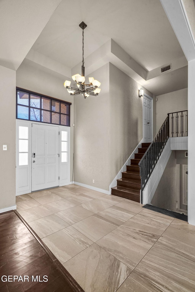 425 Golden Springs Dr, El Paso, TX 79912 - entrance foyer with stairway, baseboards, visible vents, and a notable chandelier