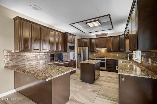 425 Golden Springs Dr, El Paso, TX 79912 - kitchen with light stone counters, under cabinet range hood, stainless steel appliances, a sink, and a center island