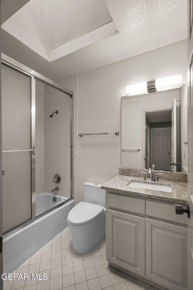425 Golden Springs Dr, El Paso, TX 79912 - bathroom with toilet, shower / bath combination with glass door, tile patterned floors, a textured ceiling, and vanity