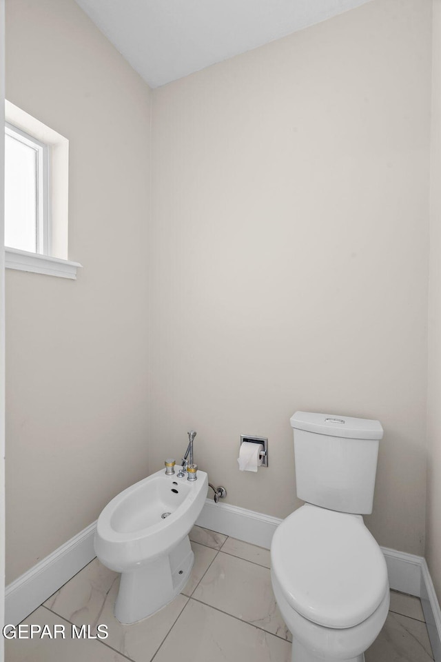 425 Golden Springs Dr, El Paso, TX 79912 - bathroom with baseboards, a bidet, marble finish floor, and toilet