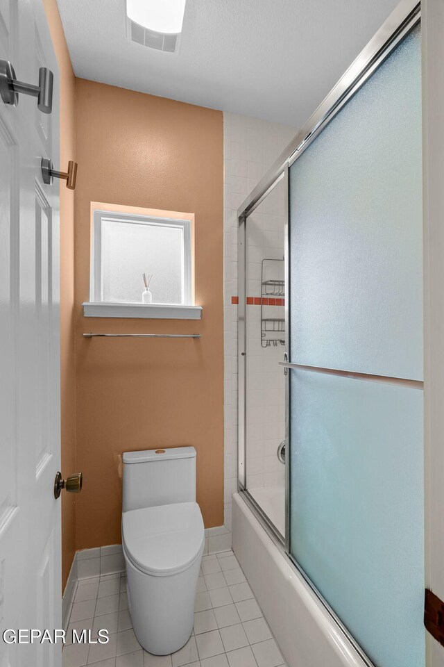 425 Golden Springs Dr, El Paso, TX 79912 - bathroom with visible vents, toilet, enclosed tub / shower combo, baseboards, and tile patterned floors