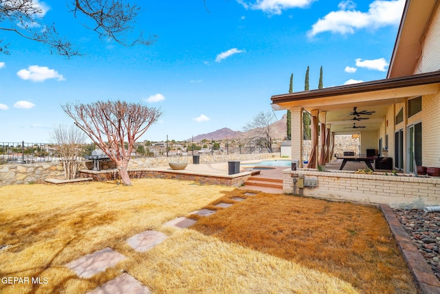 425 Golden Springs Dr, El Paso, TX 79912 - view of yard with a fenced in pool, a patio area, ceiling fan, fence, and a mountain view