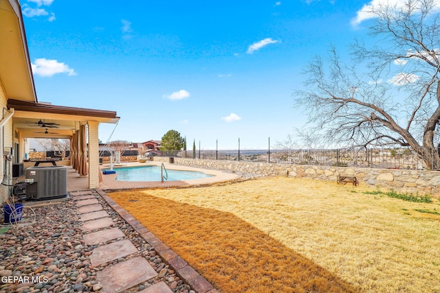 425 Golden Springs Dr, El Paso, TX 79912 - view of yard featuring a ceiling fan, a fenced in pool, a fenced backyard, and central AC unit