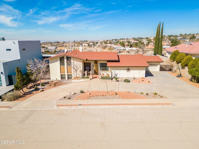 425 Golden Springs Dr, El Paso, TX 79912 - view of front of home featuring a garage, a residential view, driveway, and stucco siding