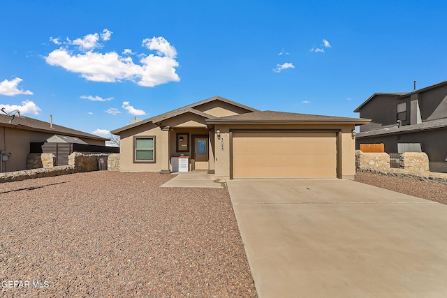 view of front of home with a garage, fence, concrete driveway, and stucco siding