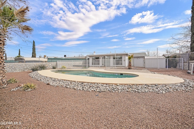 back of property featuring fence, a fenced in pool, and a patio