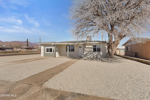 view of front of house featuring a trampoline and stucco siding