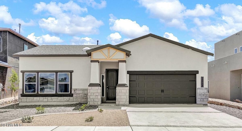 3801 Trace Pl, El Paso, TX 79938 - view of front facade featuring stone siding, an attached garage, stucco siding, and driveway