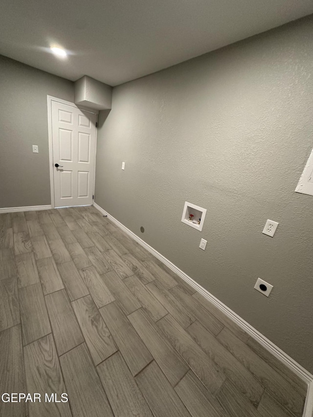 basement featuring wood tiled floor and baseboards