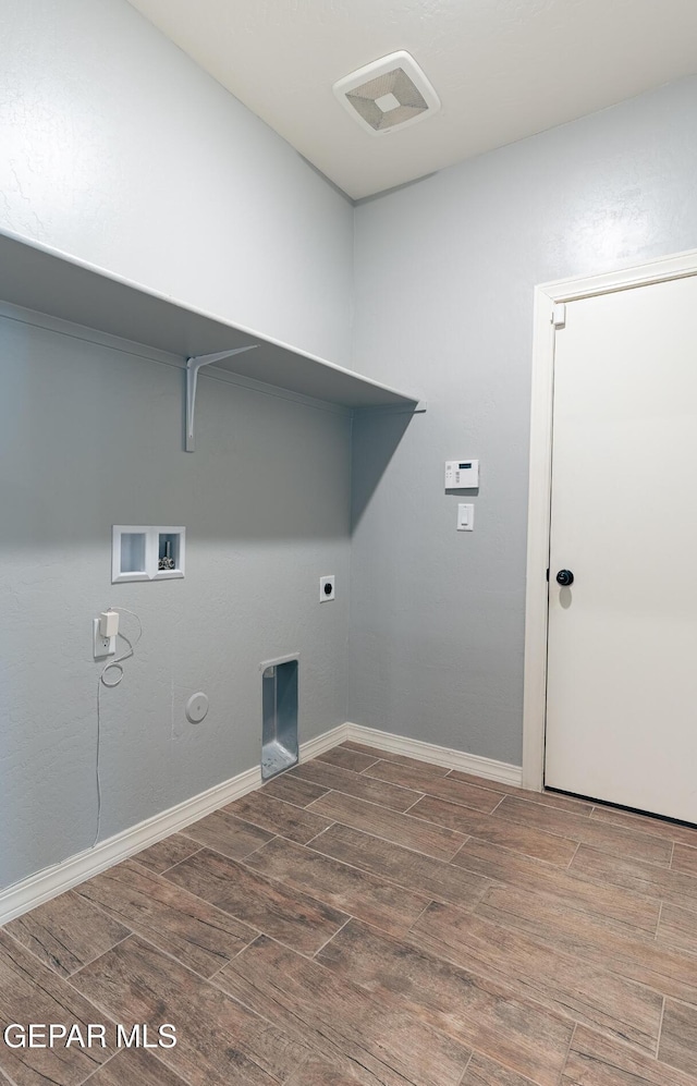 laundry area featuring hookup for a gas dryer, laundry area, visible vents, and wood tiled floor