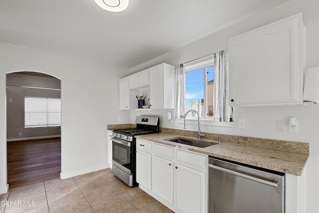 kitchen featuring white cabinetry, stainless steel appliances, and a sink