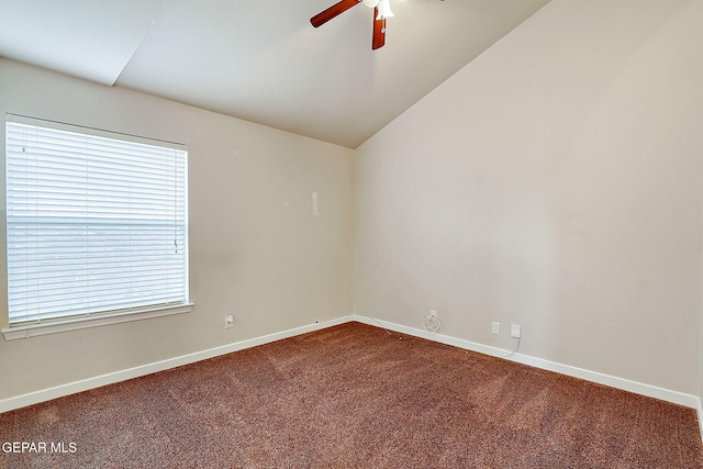 unfurnished room with carpet floors, vaulted ceiling, ceiling fan, and baseboards