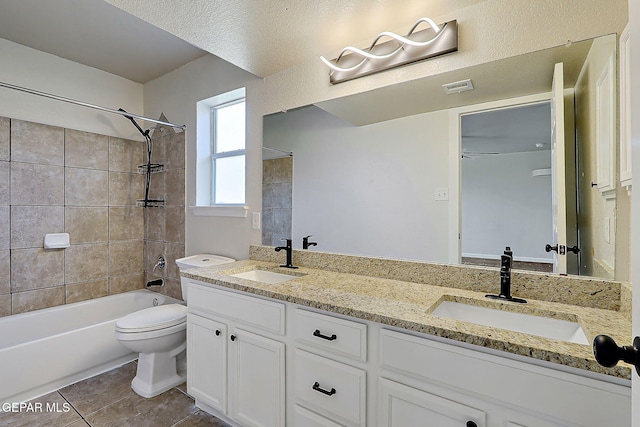 full bath featuring double vanity, tile patterned flooring, visible vents, and a sink