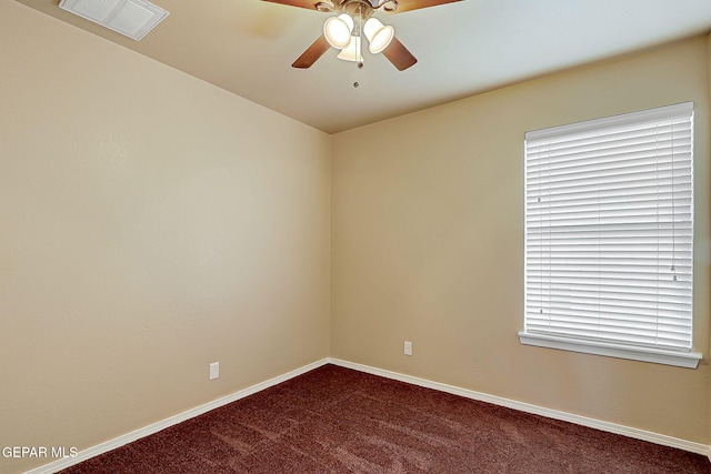 empty room featuring carpet floors, baseboards, visible vents, and a ceiling fan