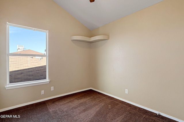 spare room with vaulted ceiling, ceiling fan, carpet, and baseboards