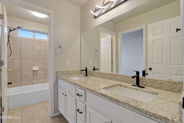 full bath with double vanity, tile patterned flooring, shower / washtub combination, and a sink