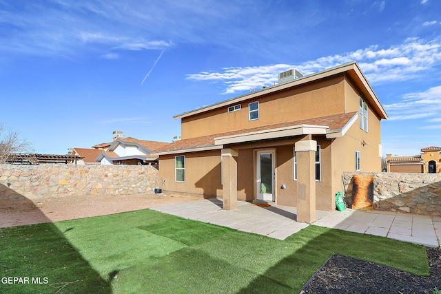 back of property featuring a yard, a patio area, a fenced backyard, and stucco siding