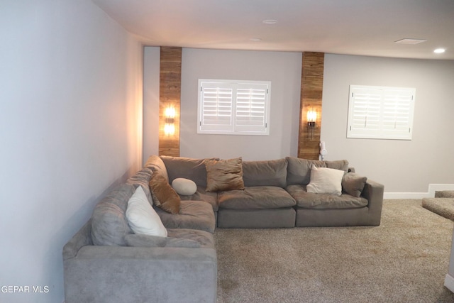 living area featuring carpet flooring and baseboards