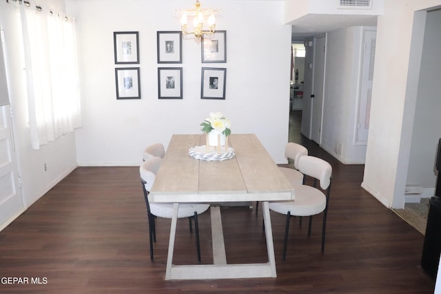 dining area with dark wood-type flooring, a chandelier, visible vents, and baseboards