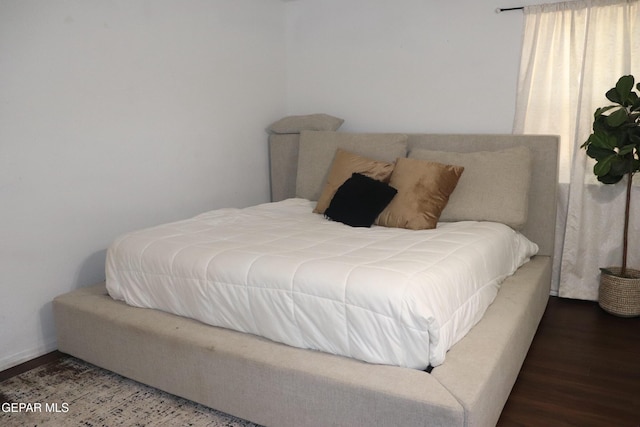 bedroom with dark wood finished floors