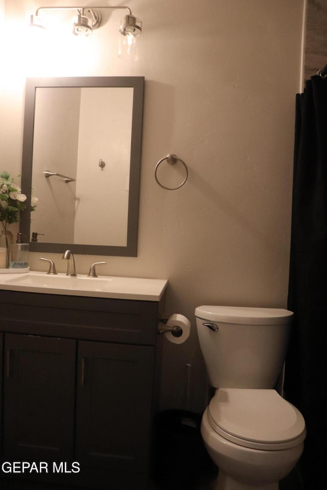 full bathroom featuring toilet and vanity