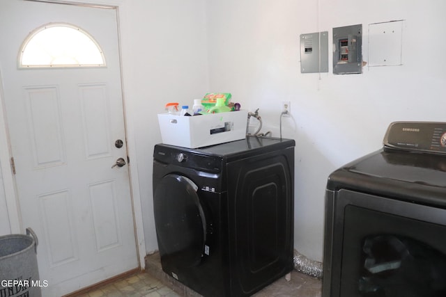 clothes washing area with laundry area, light floors, independent washer and dryer, and electric panel