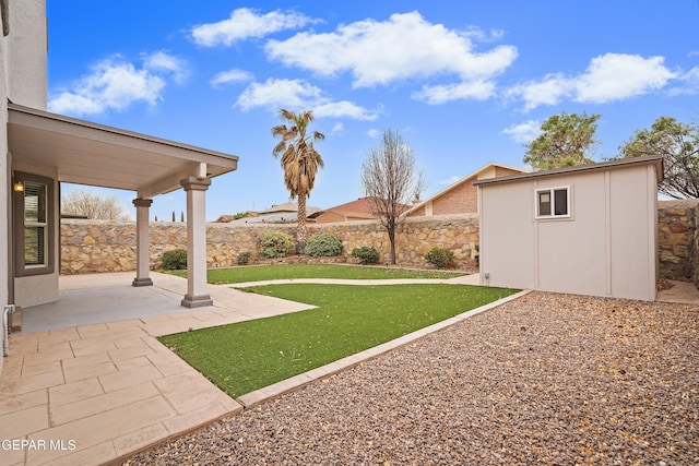 view of yard with a storage shed, a patio, an outdoor structure, and a fenced backyard